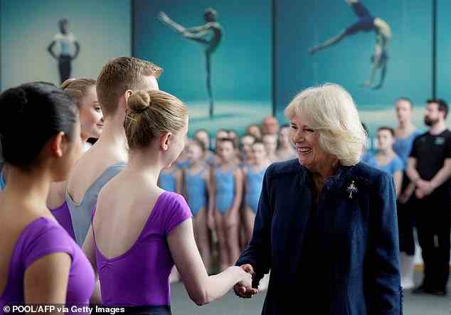 The Queen Consort shook hands with ballet dancers at the school, donning a matching ballerina brooch