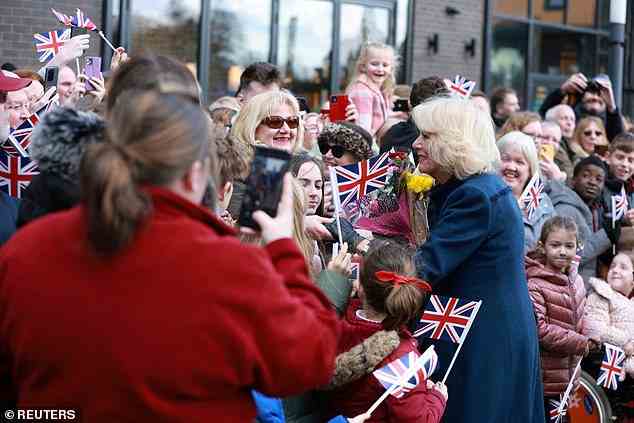 She held onto a bouquet of flowers, stopping to chat with the delighted well-wishers in Telford today