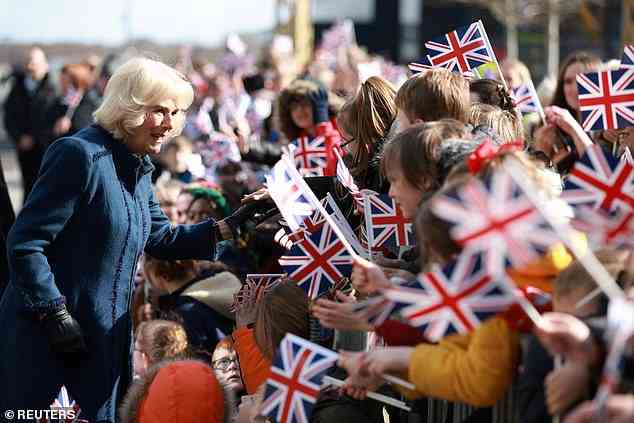 Camilla was greeted with cheerful children holding onto Union Jack flags as they gathered for her today