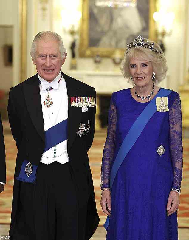 King Charles III and Britain's Camilla, the Queen Consort stand during the State Banquet held at Buckingham Palace last November