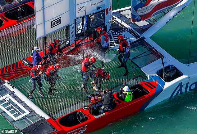 Kanadas Crew sprüht Champagner auf ihr Boot, nachdem sie das letzte Rennen am Sonntag gewonnen hat