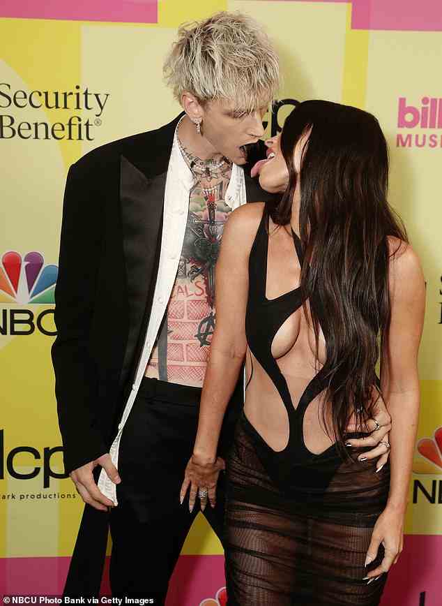 Scandalous! Before rumour s swirled that they'd split , Megan Fox and Machine Gun Kelly packed on the PDA at almost every opportunity - pictured at the 2021 BillBoard awards