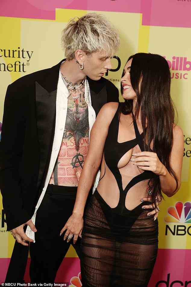 Handsy! TFox had her hands all over MGK, even seen grabbing him below the belt while they posed for the cameras. Both celebs were showing tons of skin
