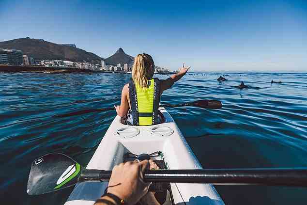 Lizzie (nicht im Bild) entdeckt gefleckte Pinguine, Delfine und Mondfische, während sie mit dem Kajak vor der Küste von Kapstadt fährt