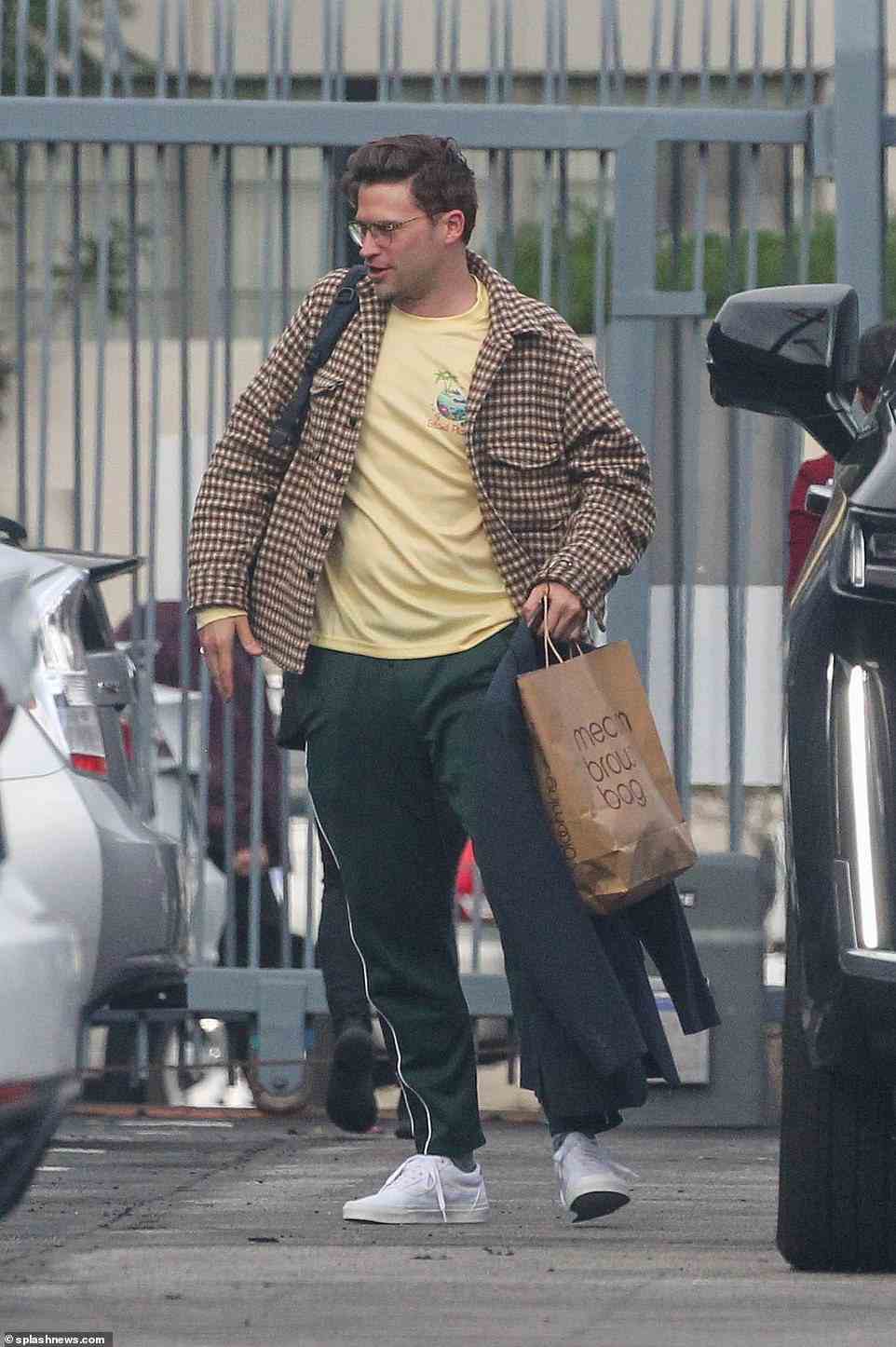 Juggling a lot: Tom Schwartz sported a yellow t-shirt, checkered brown and beige coat and sweatpants