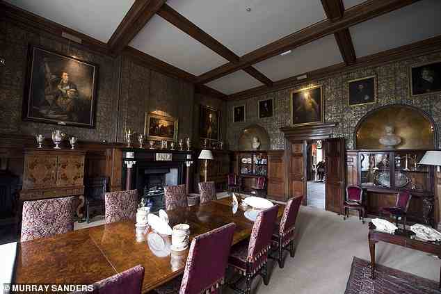 Ewan plans to make this a zero-carbon castle over the next decade (Pictured: the dining room at Muncaster)