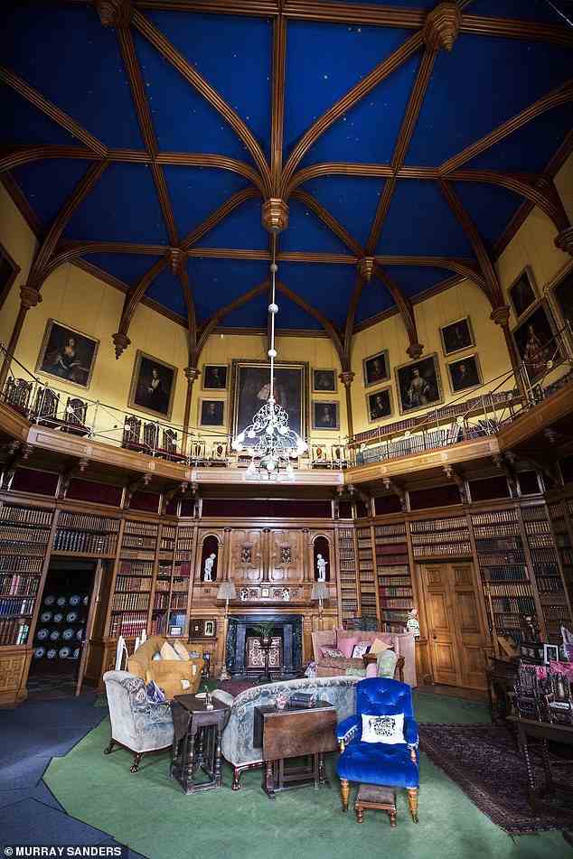 A soaring medieval chamber-turned library, with the night sky painted on its vaulted ceiling