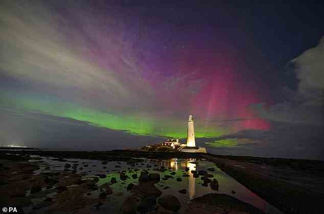 The aurora borealis, also known as the northern lights, glow on the horizon at St Mary's Lighthouse in Whitley Bay on the North East coast. Picture date: Thursday March 23, 2023