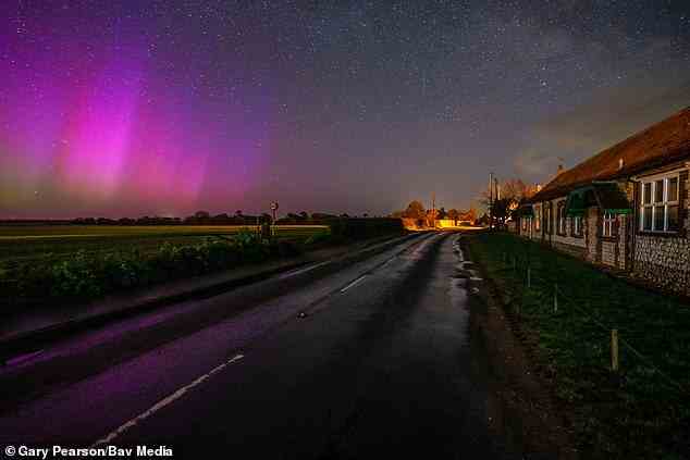 Photo shows the Northern Lights in Titchwell in Norfolk in the early hours of Friday morning. Aurora form when charged particles from the sun penetrate the earth's magnetic field and collide with atoms and molecules to create bursts of light