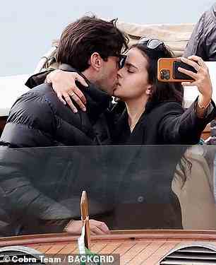 Selfie: Stella wrapped her arm around Arg as the couple kissed on the boat trip