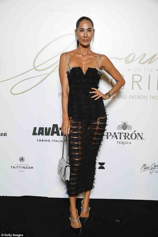 Lindy Klim showed off her trim - and tanned - figure in a perfect black maxi dress with sheer cutouts