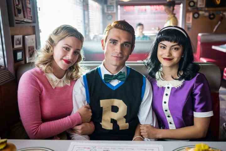 Ein Junge und zwei Mädchen im Teenageralter sitzen in einer Nische in Riverdale.
