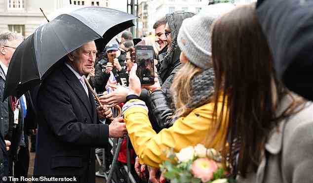 Royal fans were wrapped up and wore waterproof outfits to brave the drizzling rain in a bid to catch a glimpse of the King