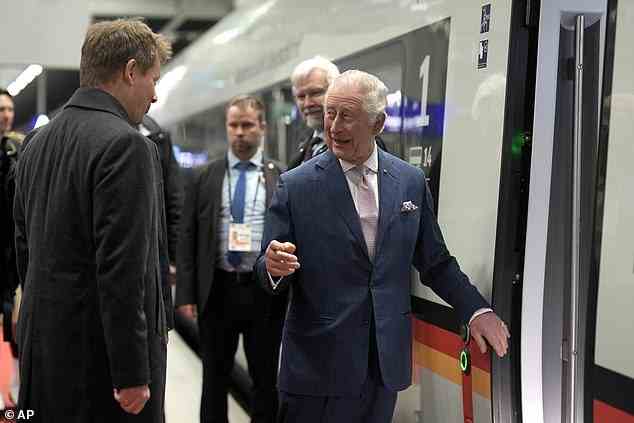 The King appeared to make a joke as he got ready to board the train to Hamburg ahead of a busy day of engagements