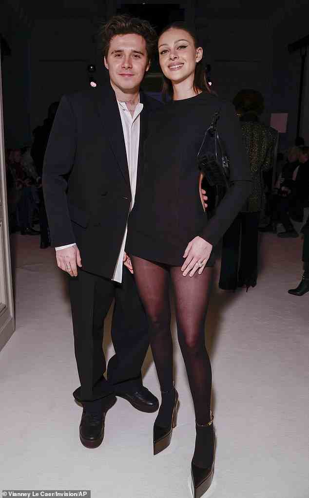 Couple: Nicola Peltz put on a very leggy display as she posed at Valentino's Paris Fashion Week show with her husband Brooklyn Beckham on Sunday night