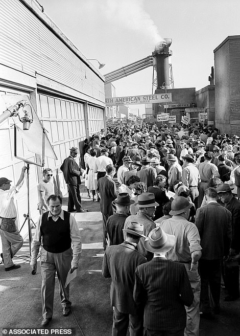 Extras swarm around a Warner Bros studio set for a scene in I Was A Communist For The FBI