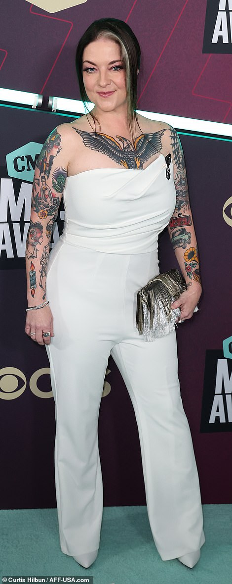 Showing off her ink: Ashley McBryde, 39, put her numerous tattoos front and center in a classy sleeveless white bodysuit