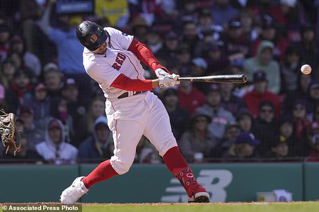 The Red Sox's Adam Duvall hits a two-run single against the Orioles during Sunday's 9-5 win
