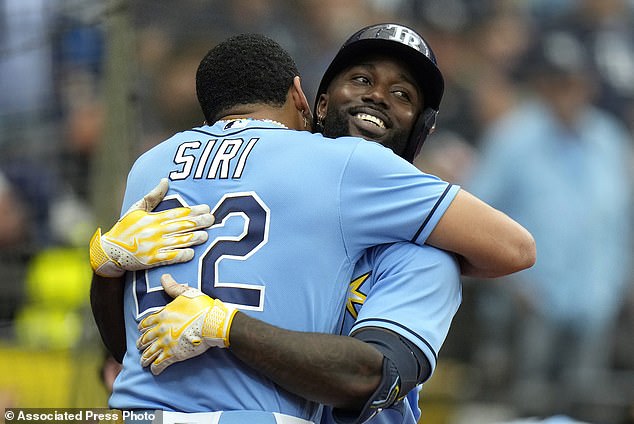 Tampa Bay Rays' Randy Arozarena hugs Jose Siri (22) after Arozarena hit a solo home run
