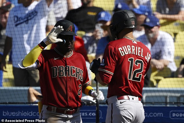 The D-Backs' Lourdes Gurriel Jr. is congratulated by Geraldo Perdomo after scoring on a bunt single in the ninth inning