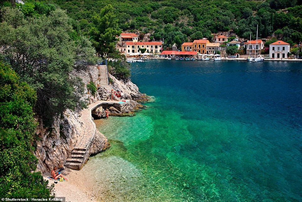 KIONI BEACH, THE VILLAGE OF KIONI, ITHACA: 'This photogenic and somewhat hidden micro beach is perfect for a dip after lunch in Kioni, with pebbles and rocks falling away into azure depths,' the book reveals. Coordinates: 38.4485, 20.6901