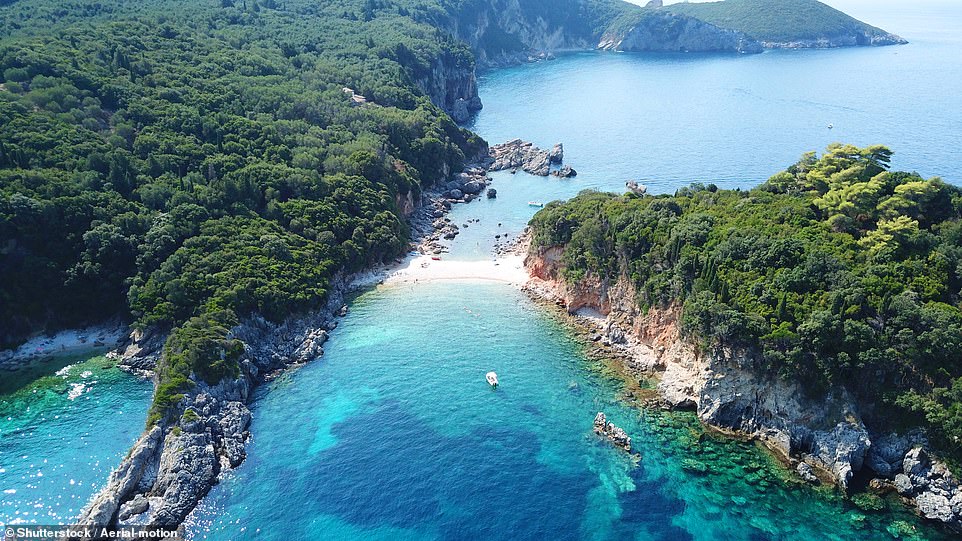 LIMNI BEACH, CORFU: 'This double-sided white pebble beach connects the land to an outcrop with a small cave and rock pools,' reveals the book, adding that the beach, near the village of Palaiokastritsa, is relatively quiet because it's 'somewhat tricky' to access. Coordinates: 39.6655, 19.7239