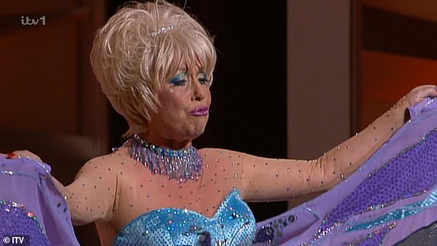 Entertaining the masses: Paul took part in a TV performance as nipple-tassel-twirling Lily with the late Barbara Windsor