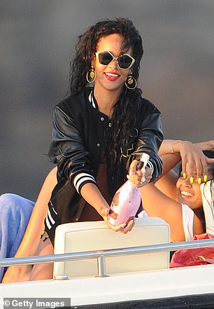 Rihanna is seen opening a bottle on a boat on July 28, 2012 in Portofino, Italy