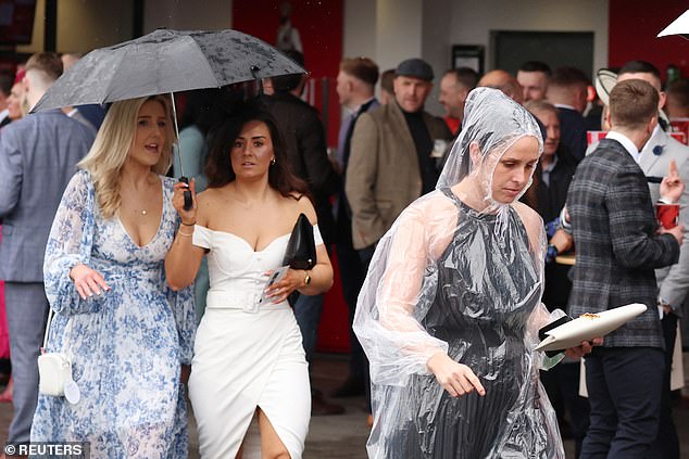 One attendee took no chances with her long-planned outfit and covered herself with a transparent plastic poncho