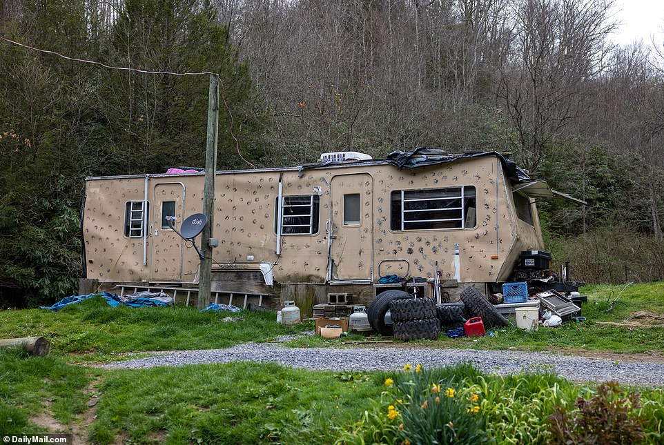 They have several animals running around the property, which is crammed with broken-down vehicles, and a trailer which Larry resides in near to a chicken coop, surrounded by a small creek