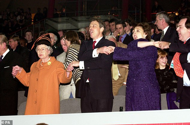 Queen Elizabeth II and Prime Minister Tony Blair and wife Cherie, singing 'Auld Lang Syne' during midnight celebrations to welcome in the new millennium at the Millennium Dome in Grenwich, south east London in 2000
