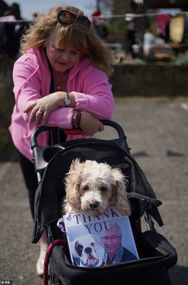 Jaqueline Lawrie, 48, from Barnet in north London, travelled down to pay her respects and her cocker-poo Millais, 10, was sitting in a pushchair with a placard around his neck showing O'Grady with a dog, saying simply 'thank you'