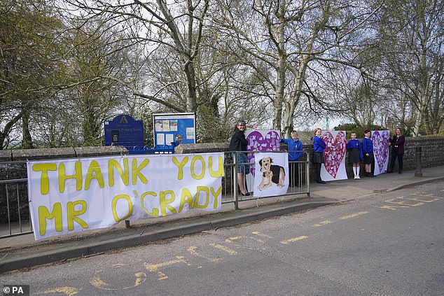 'Thank you Mr O'Grady!': Heartfelt tribute to the late entertainer by pupils and teachers from Adlington Primary School, as they hold up banners and drawings along the funeral procession route