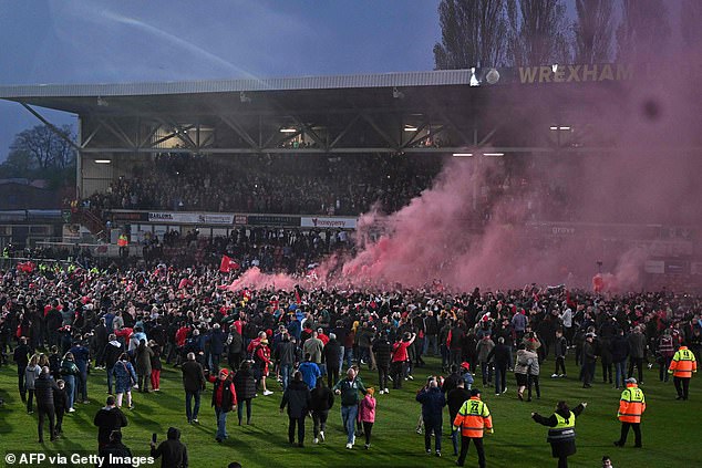 Big night in Wrexham: Fans storm the pitch after being promoted to the Football League from their 3-1 win against Boreham Wood
