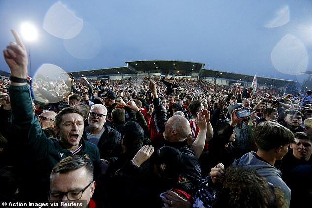 Jubilation: Fans cheer and chant with joy at the huge win at their home stadium on Saturday night