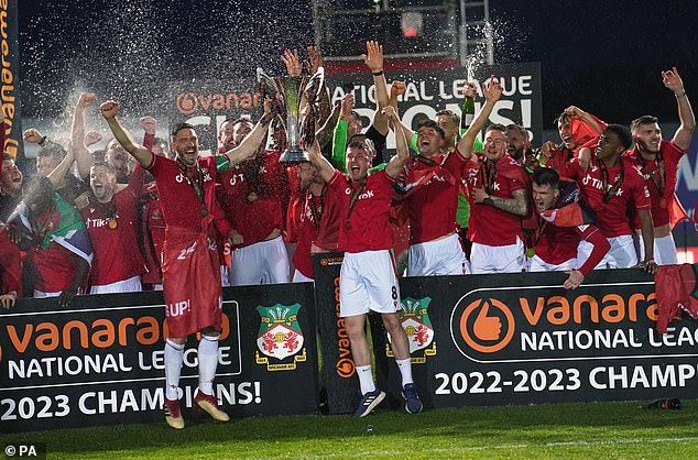 Celebrations: The Wrexham Football Club players jump with joy after their huge win at their home grounds on Saturday night