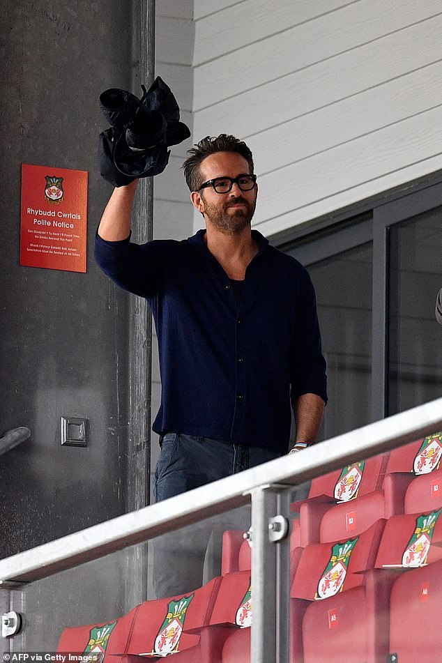 Ready to go: Wrexham owner Ryan Reynolds waves to fans ahead of the English National League football match between Wrexham and Boreham Wood at the Racecourse Ground Stadium in Wrexham, north Wales, on Saturday