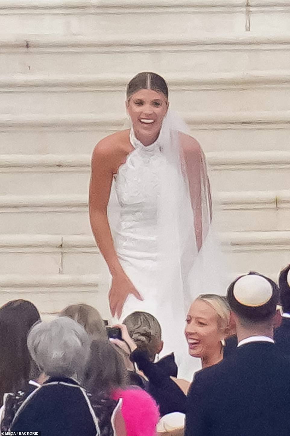 Breathtaking: For the day of the ceremony, Sofia chose a delicate gown with iridescent white sequins and a criss-cross neckline, which was inspired by a look from Chanel's fall 2023 collection