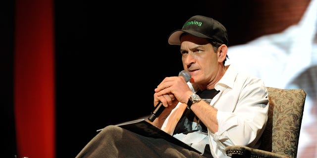 Charlie Sheen wears a #winning hat on stage