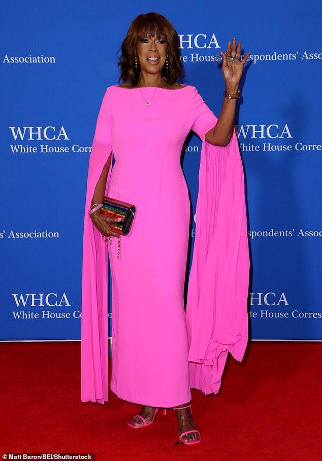 CBS broadcaster Gayle King waved to paparazzi while posing on the red carpet with hot-pink, full length dress - like something out of Legally Blonde