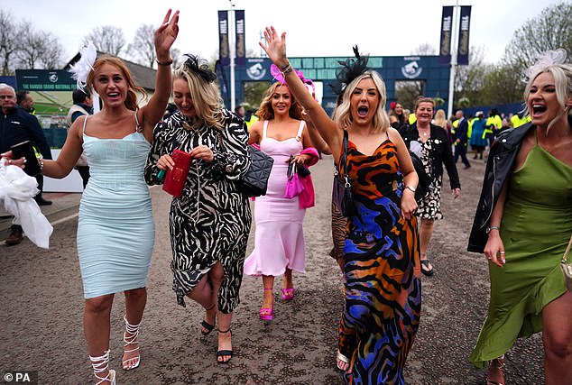 Here come the girls! This glamorous group raised their arms as the action got underway for another raucous day