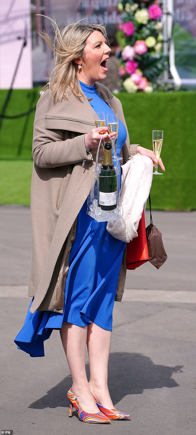 This racegoer, dressed in a chic sapphire dress and vibrant multicoloured heels, cracked open the bubbly and had three glasses ready for her pals