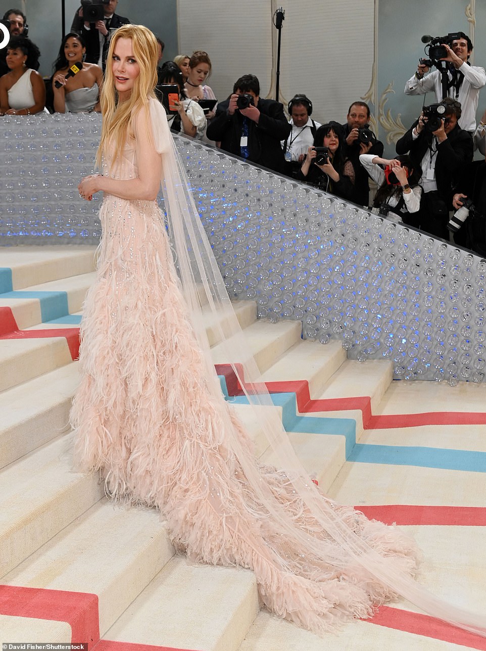The Moulin Rouge star looked absolutely breathtaking in a pale pink sequinned Chanel gown with a dramatic long feathered train