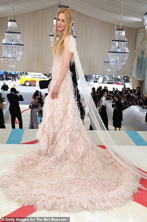 The dress also features tulle ties at her shoulders, which run down the train like a veil
