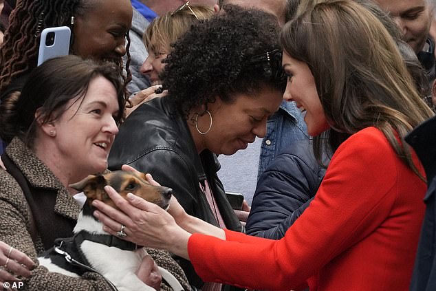 Kate was beaming as she greeted a royal fan who was joined by her adorable dog during a visit to Soho today
