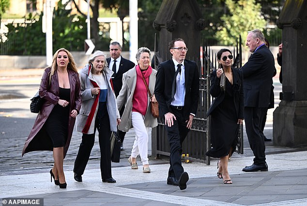 Members of the public are seen arriving at St Patrick's Cathedral on Friday