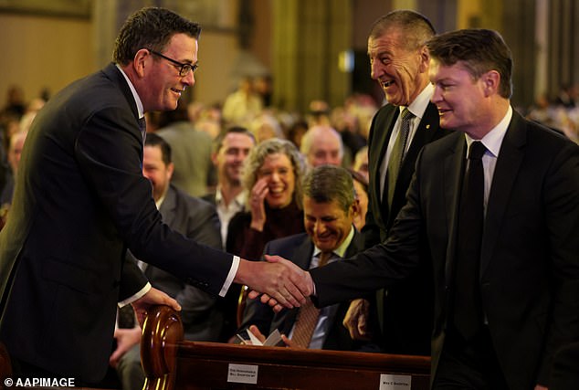 Mr Andrews shook the hand of Public Transport Minister Ben Carroll during the service