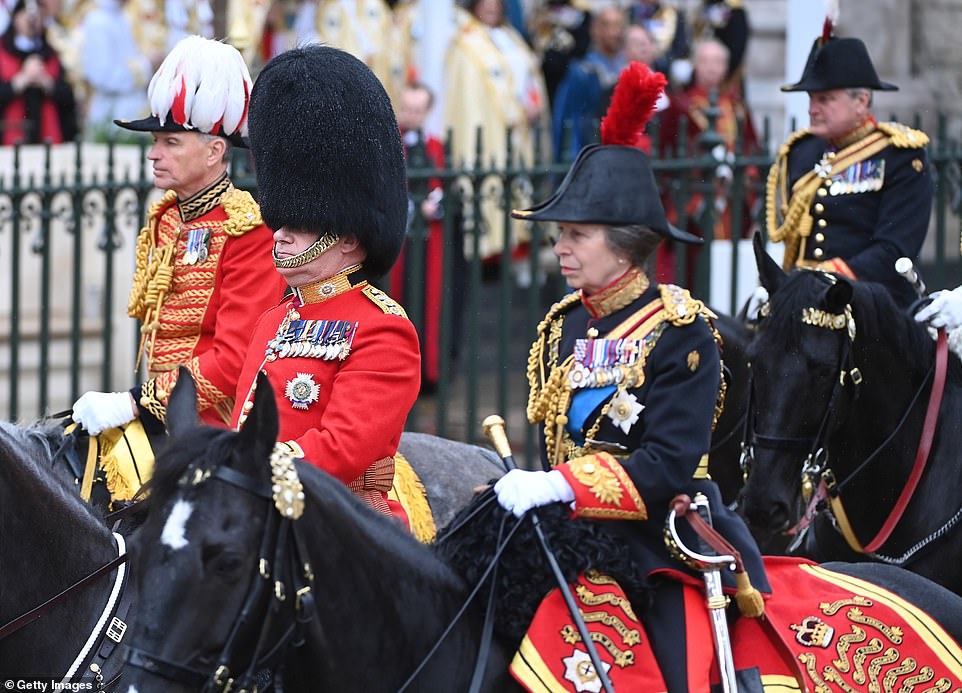 Princess Anne, Princess Royal rides on horseback behind the gold state coach carrying the newly crowned King and Queen