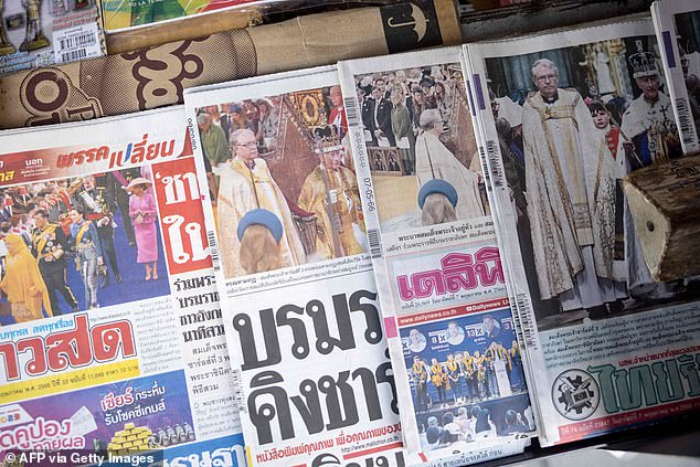THAILAND: Front pages of Thai newspapers, featuring coverage of the coronation Britain's King Charles III, are pictured at a magazine stand in Bangkok on May 7