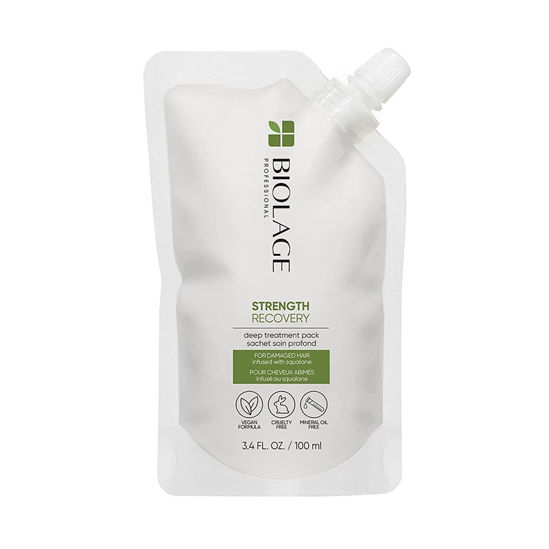 A clear plastic sachet of the white Biolage Strength Recovery Deep Treatment Hair Mask on a white background